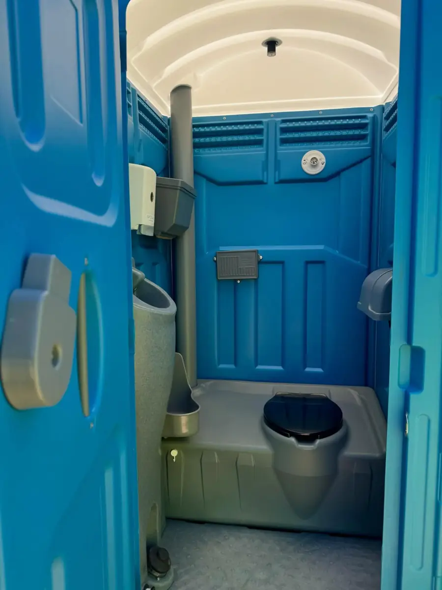 Deluxe flushing porta potty interior with a built-in hand sink