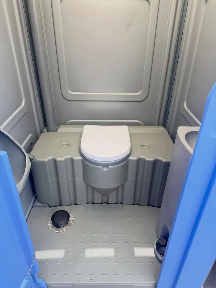 Clean toilet seat and floor inside a standard portable toilet