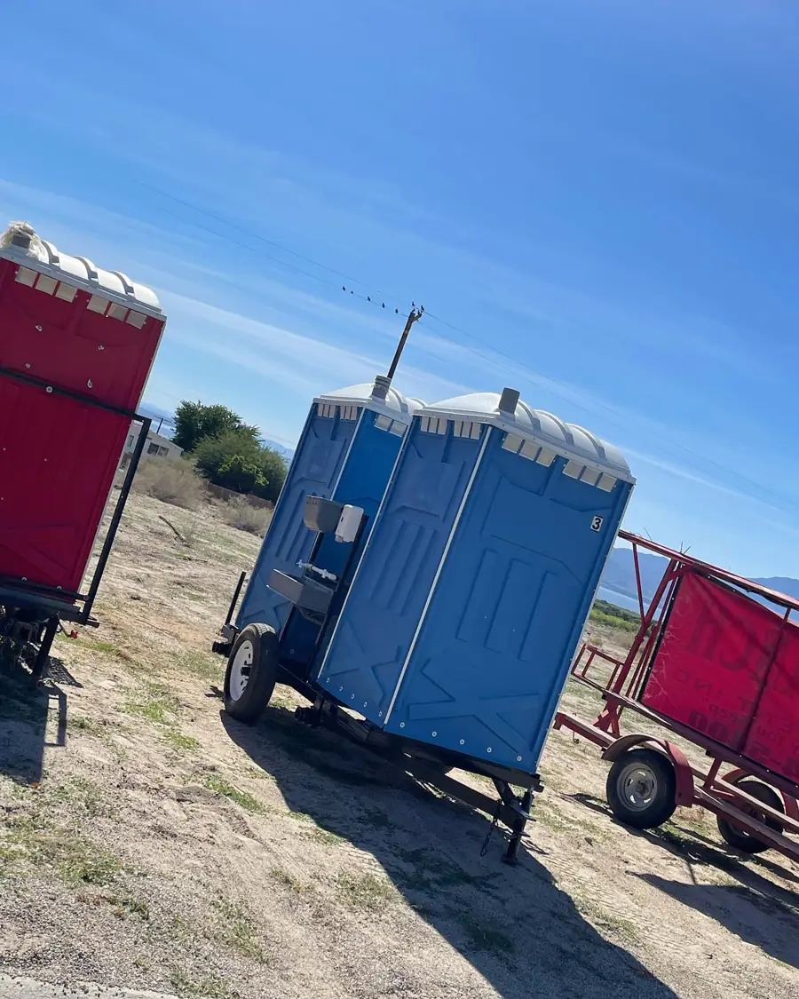 Side view of a two-unit towable porta potty trailer